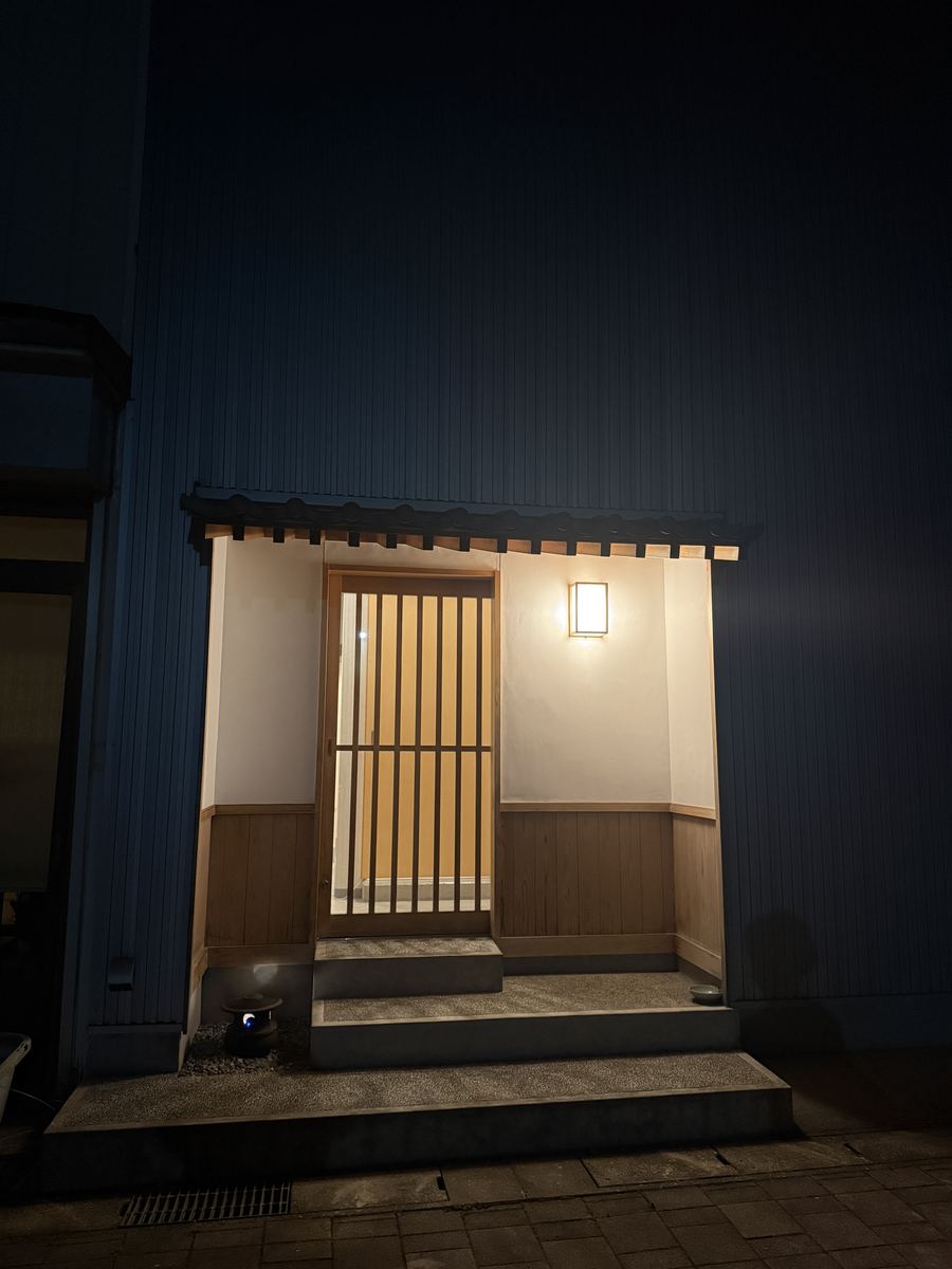 A lit doorway after dark